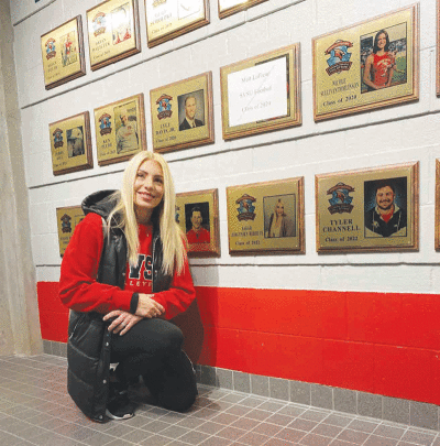  Sarah Jorgensen and her hall of fame plaque are pictured in SVSU’s brand new hall of fame hallway. 