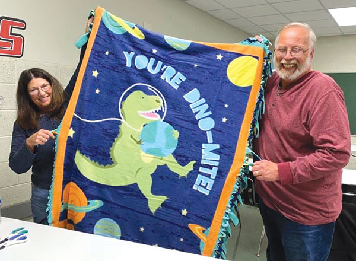  Optimist Club of St. Clair Shores members Pattie and Joe Wielgot make “no sew” blankets to benefit the Macomb Foster Closet’s collection drive. 