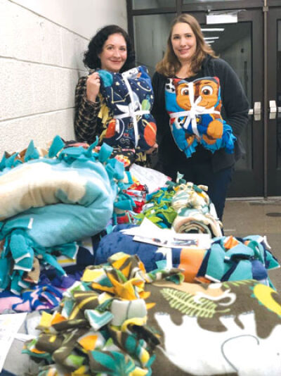  St. Clair Shores City Councilwoman Candice Rusie and her sister Cassandra Rusie take part in a previous “blanket-making party” to benefit the Macomb Foster Closet, organized by the Optimist Club of St. Clair Shores. 