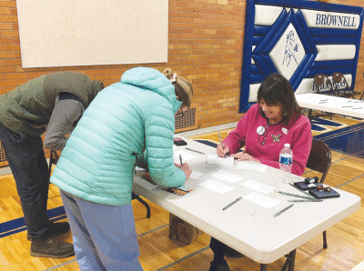  Grosse Pointe Farms Election Official Claudia Gostine assists voters at Precinct 5 at Brownell Middle School on Election Day. 