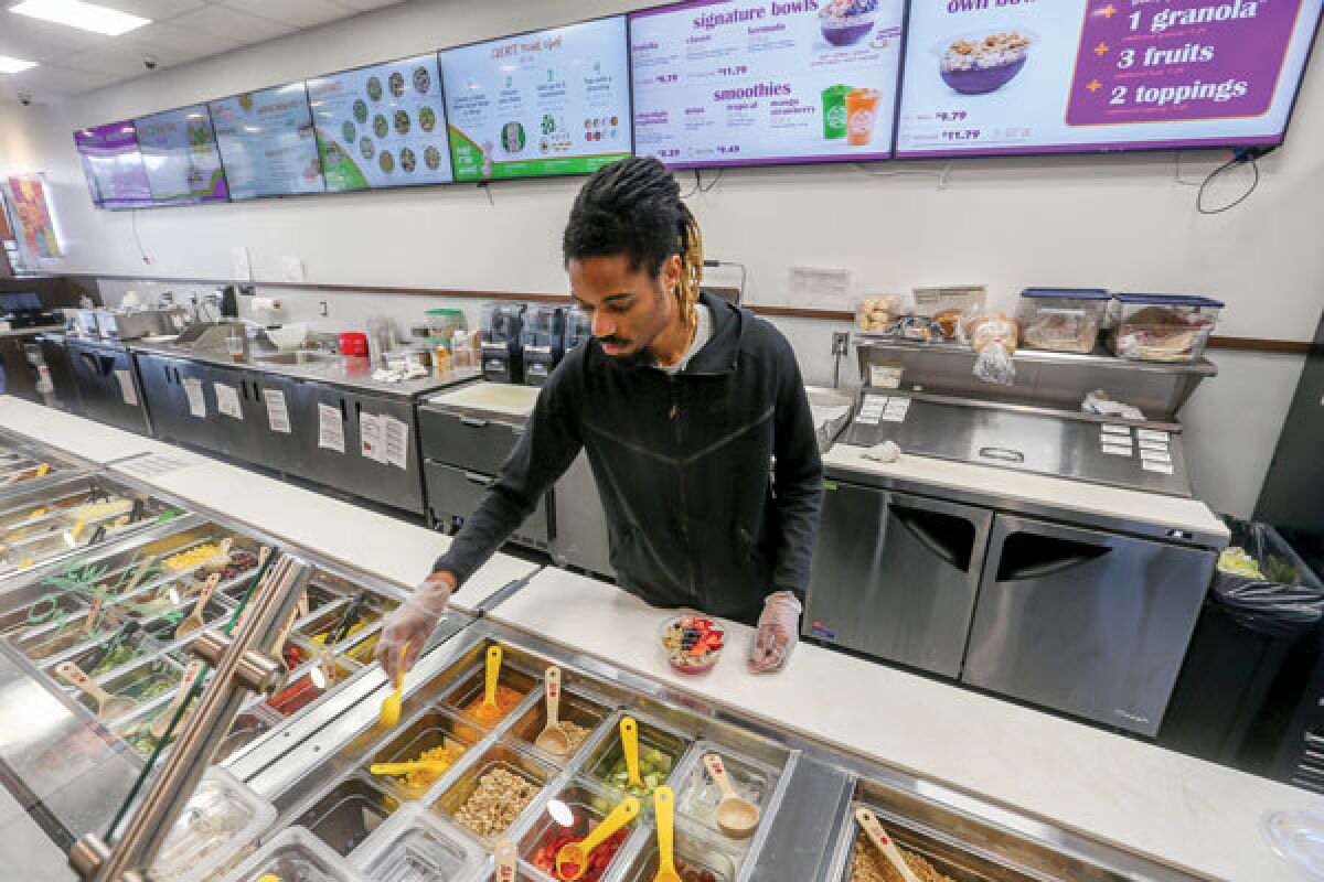  Bryan Hairston, who is an assistant manager and shift lead at Saladworks/Frutta Bowls in West Bloomfield, prepares a Frutta Bowl. Hiring employees is one of the ways businesses help support local economies. 
