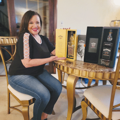  Local singer/musician Tosha Owens, pictured, has been collecting Jack Daniel’s bottles with her friend, Ursula Ketchum, for almost 30 years. 