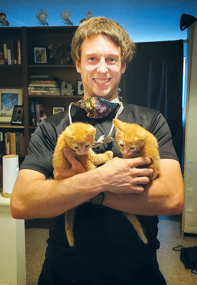   Foster pet dad Nick Taylor shows off two of his recent  houseguests, Theo and Cleo. 