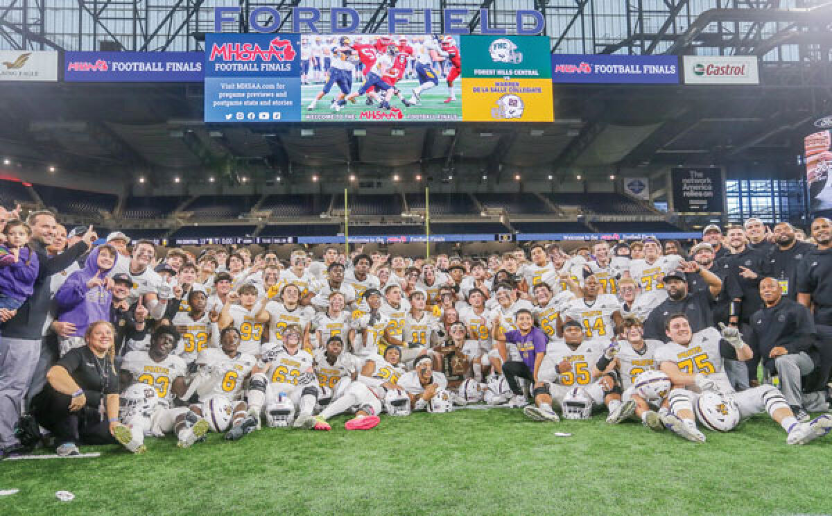  De La Salle takes a team photo after their win against Forest Hills Central in the MHSAA Division 2 state championship at Ford Field on Nov. 25. 