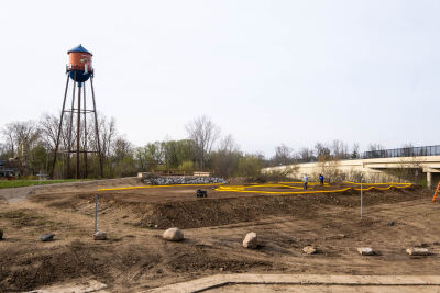  Workers begin laying the yellow piping that will serve as the perimeter for the new racetrack for RC cars at Novi's Water Tower Park May 5. 