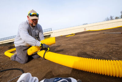  Novi Parks, Recreation and Cultural Services employee Jeremia Pilarski works on the perimeter of a new racetrack for remote controlled cars May 5 at Novi’s Water Tower Park. 