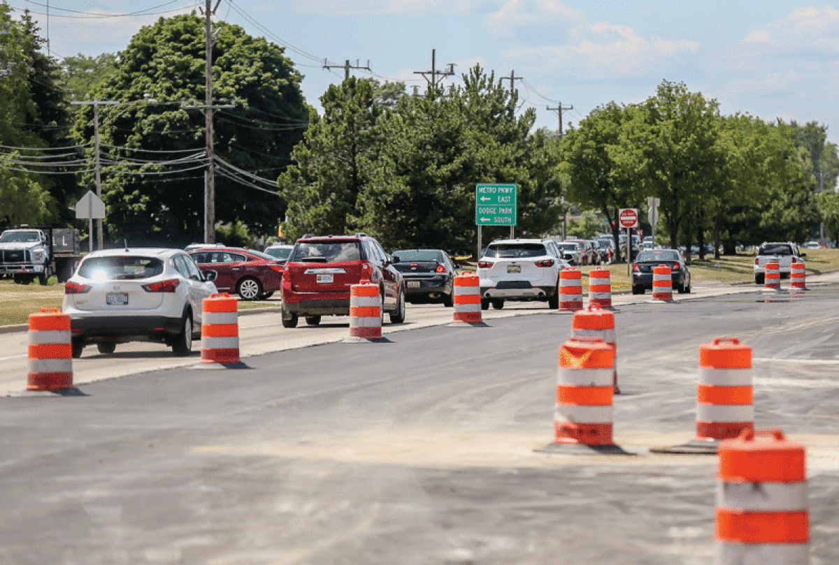  Motorists on westbound Metropolitan Parkway, west of Dodge Park Road, deal with orange construction barrels. 