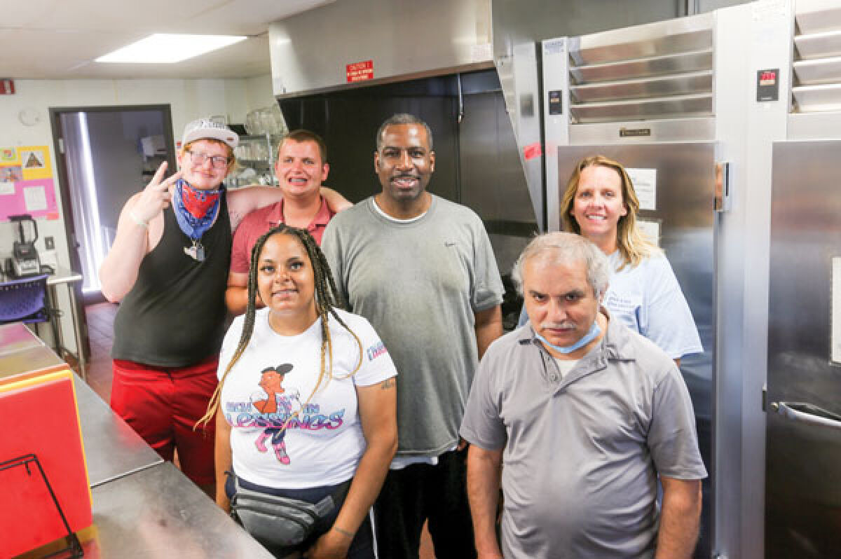  Members of the hospitality services unit stand for a photo in the kitchen at the Easterseals Michigan Dreams Unlimited Clubhouse during an open house June 21. Meals are prepared daily and are available to members for $1.50. 