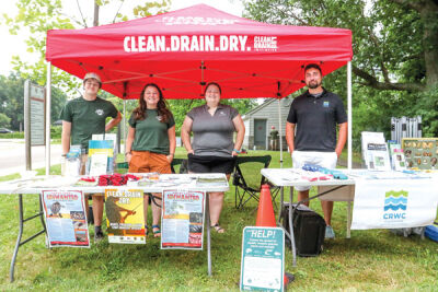  From the left, Ian Keller, Tyler Lidgard, Kelsey Bockelman and Eric Diesing participate in an event to help raise awareness about the spread of aquatic invasive species in local waterways. 