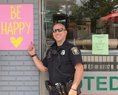  Officer Joe Dusovic, of the Rochester Police Department, shows it’s important to “be happy.” 