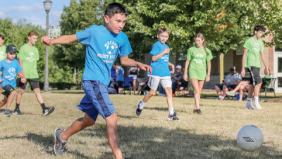  Evan Szepytowski, 12, of Macomb Township, scores a goal at a Buddy Soccer session as players and buddies watch on. 