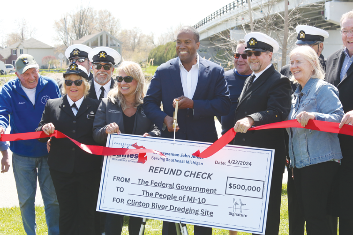  John James, local officials and representatives from the North Star Sail Club celebrate the allocation of $500,000 in federal funds to maintain a dredging disposal facility. 