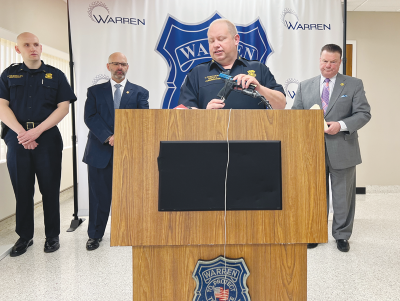  Warren Police Commissioner Charles Rushton demonstrates how to lock and unlock a gun at an April 23 press conference. 