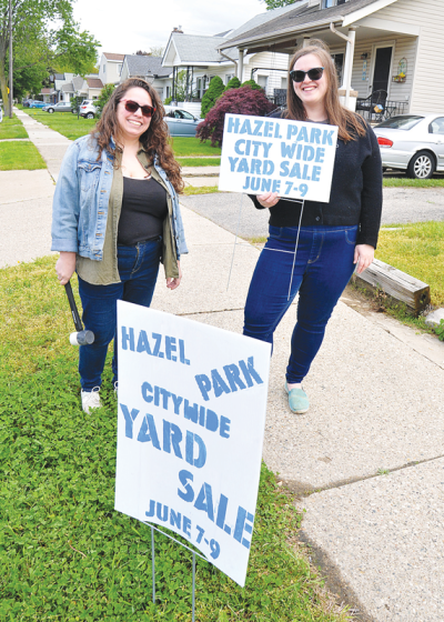  Sisters-in-law Margaret Donnelly, left, and Kathryn Ellywicz prepare to post signs promoting the Hazel Park Citywide Yard Sale & Freecycle, set to take place at locations across the city the weekend of June 7-9.  