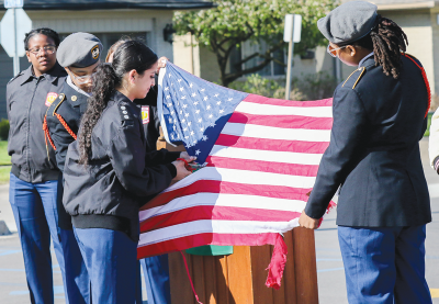   A group of Center Line High School JROTC cadets properly disassemble an American flag during the ceremony April 22.  