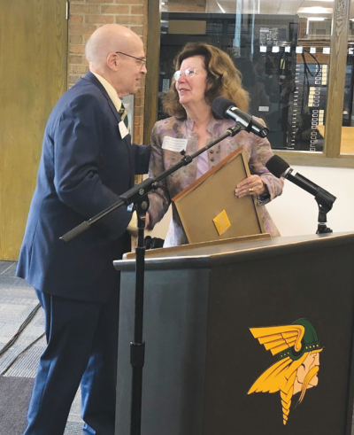  During the 13th annual Community Luncheon May 17, Grosse Pointe Woods Mayor Arthur Bryant presents former Grosse Pointe Public School System Superintendent C. Suzanne Klein with a proclamation from the Michigan Legislature to mark the Grosse Pointe North High School library being named in Klein’s honor. 