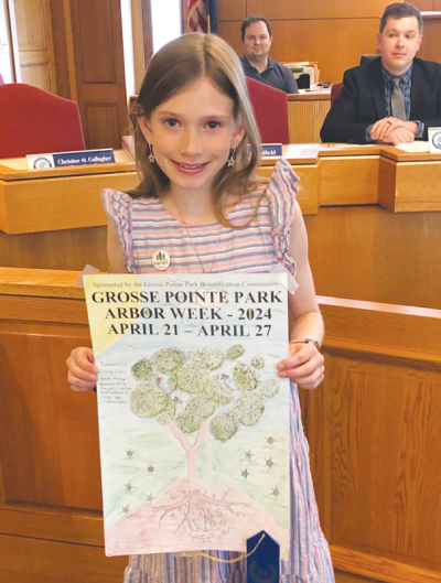  Defer Elementary School student Catherine Palmer holds her Arbor Day poster contest entry, which won first place in Grosse Pointe Park’s poster contest this year. 