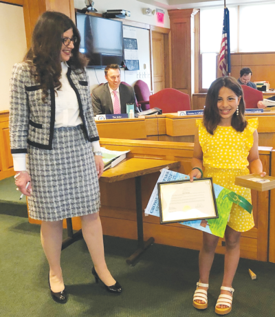  From left, Grosse Pointe Park Mayor Michele Hodges presents Defer Elementary School student Maria Bourdane with a certificate and city tile for being a runner-up in the city’s annual Arbor Day poster contest. 