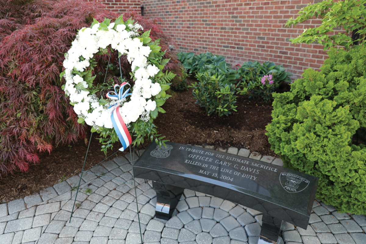   A memorial wreath was placed at the Officer Gary Davis Memorial Bench by the Honor Guard during a 20th anniversary memorial service May 13. 