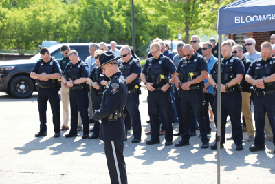  Officers from the Bloomfield Township Police Department bow their heads in remembrance of Officer Gary Cooper Davis during a 20th anniversary memorial service May 13. 