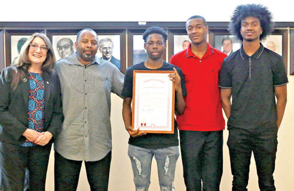  At the May 13 Eastpointe Board of Education meeting, state Sen. Veronica Klinefelt, D-Eastpointe, far left, presented members of the Eastpointe High School varsity basketball team with a state tribute. The team won a district title this season. Pictured with Klinefelt, from left, are coach VaShawn Glover, juniors Raymond Willis and Kean Davison, and senior James Phillips. 