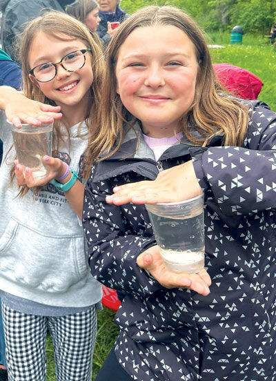  Students and staff from Troy District Schools released salmon into the Clinton River at River Bends Park May 9. 