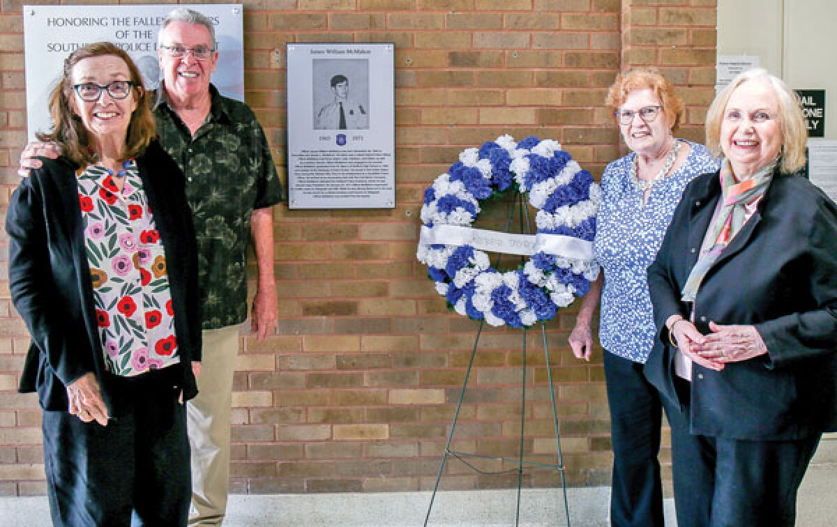 The siblings of Officer James W. McMahon — Eileen McMahon, Dennis McMahon, Kathleen Shea and Julie O’Reilly — pose with the plaque honoring their late brother in the Southfield Police Department. 