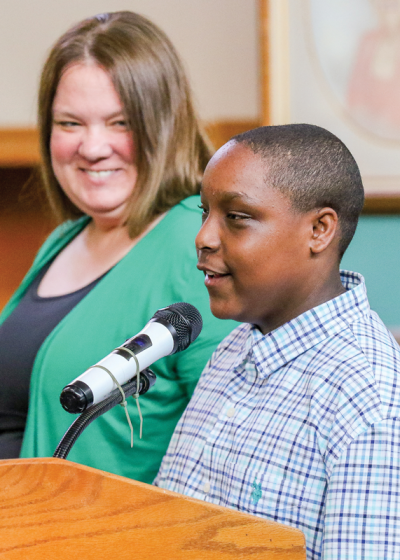  “I love all y’all,” Wolfe Middle School eighth grader Kristoffer Wright, right, said after receiving a Turn Around award May 14 from school social worker Erin Roddis, who nominated him. 