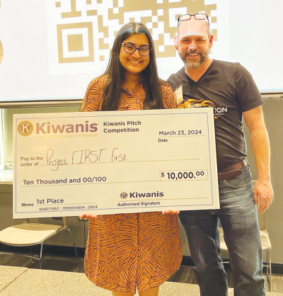  Gene L. Klida Utica Academy for International Studies junior Adeline Paul receives a $10,000 grant after her successful presentation in the Kiwanis Pitch competition in March. 