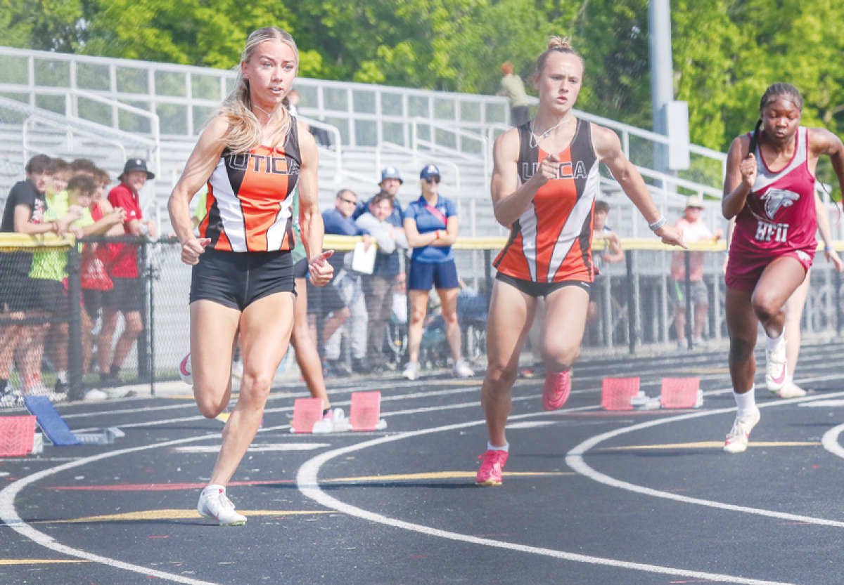  Utica seniors Emma Puwal, left, and Zoe Zeiser compete in the 200-meter. 