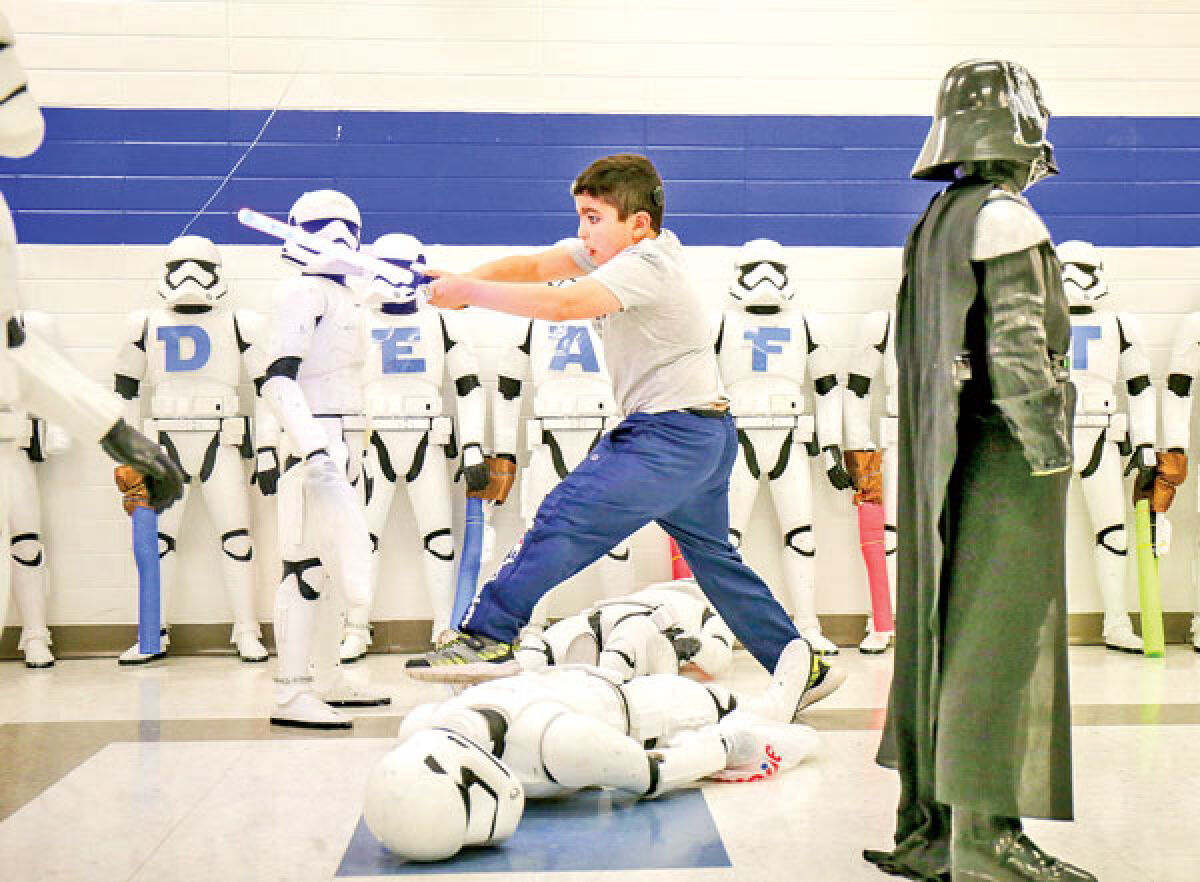  With some enthusiasm, second grader Joseph Nazerat takes down stormtroopers with his lightsaber. 