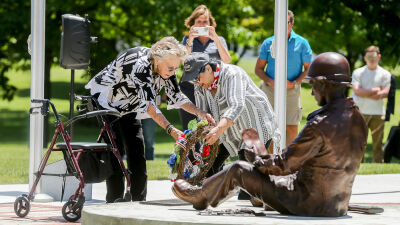  Iola Sobeck, John Sobeck's widow, left, and Linda Alvira, the daughter of D-Day veteran Clifford Alvira, a Royal Oak resident who passed away April 24 at the age of 99, lay a wreath at the Michigan World War II Legacy Memorial honoring those who fought on D-Day in 1944. 