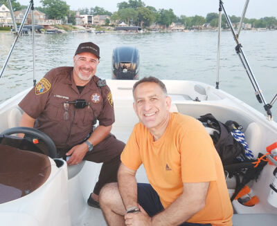  Keego Harbor Mayor Rob Kalman is pictured with an employee of the Oakland County Sheriff’s Office Marine Patrol. Keego has contracted with Oakland County for patrols on Cass Lake this year and next.  