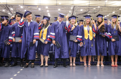  The Cousino High School Class of 2024 graduates cross their tassels to make it official.  