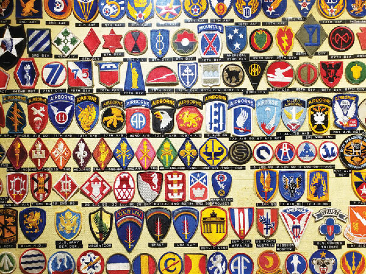  U.S. military shoulder insignia patches line the wall of the Bruce Post in St. Clair Shores. 