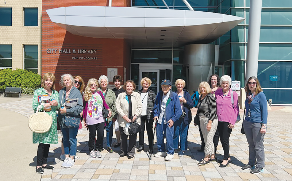  Seniors gather in front of Warren City Hall with librarians Lisa Martin and Julianne Novetsky after the Civic Center Library hosted a trip to the DIA for a Motown concert and museum tour.  