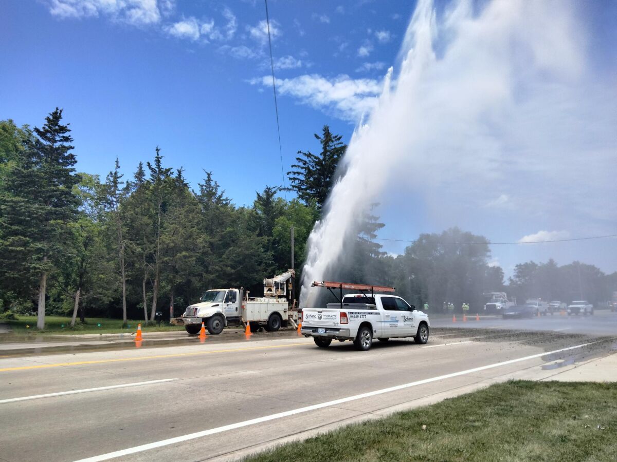  Crews work at the site of a water main break in Troy June 13. 