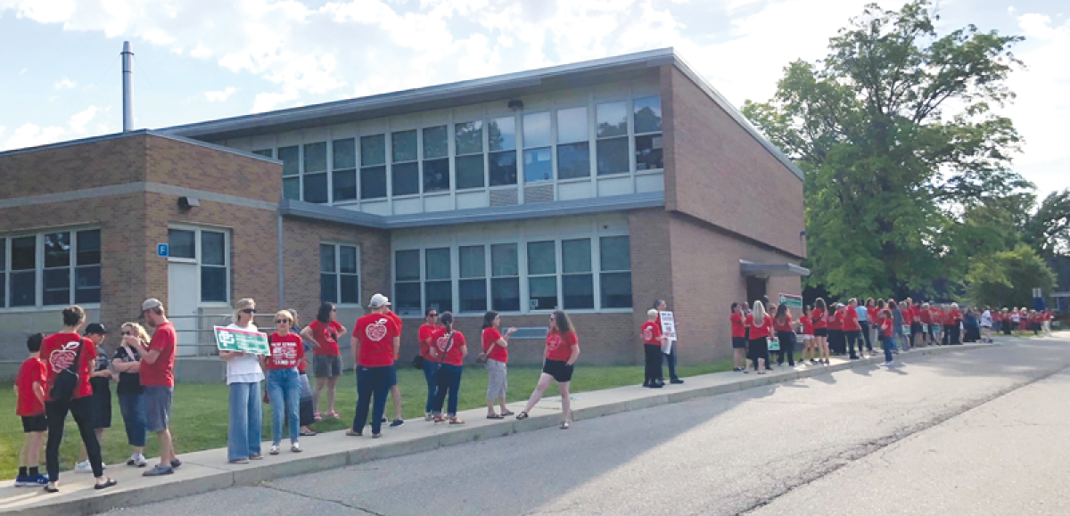  In matching red T-shirts and carrying signs, a large group of Grosse Pointe Public School System teachers gathered outside Brownell Middle School June 12 to show their desire to get a new contract soon. 