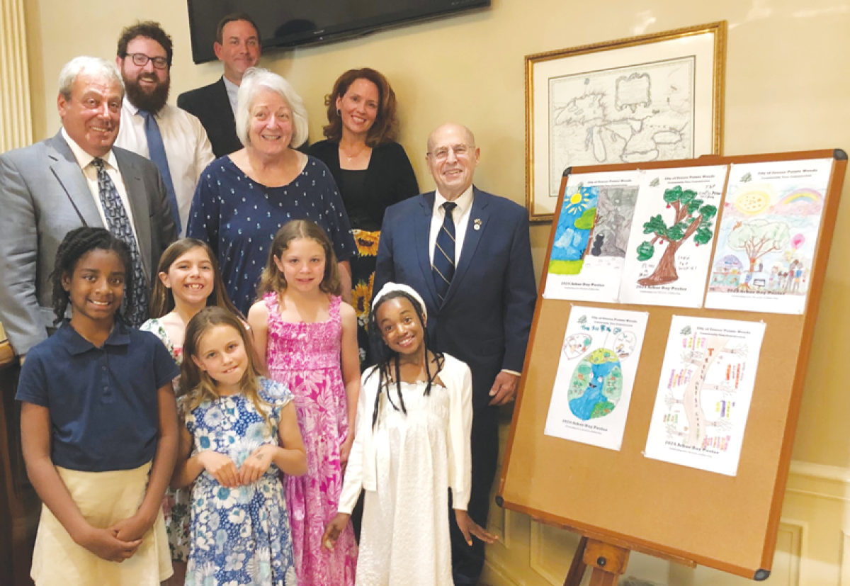  Winners of Grosse Pointe Woods’ annual Arbor Day poster contest pose with members of the Woods City Council June 3. 