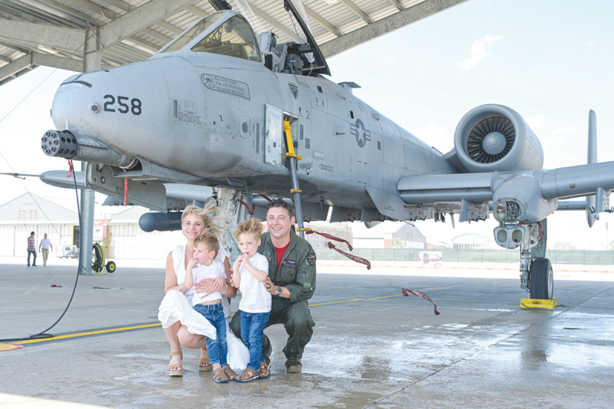  Michigan Air National Guard Maj. Jason Holm poses with wife, Cristina, and children, Harrison and Hendrick, after completing his final flight on June 13.  