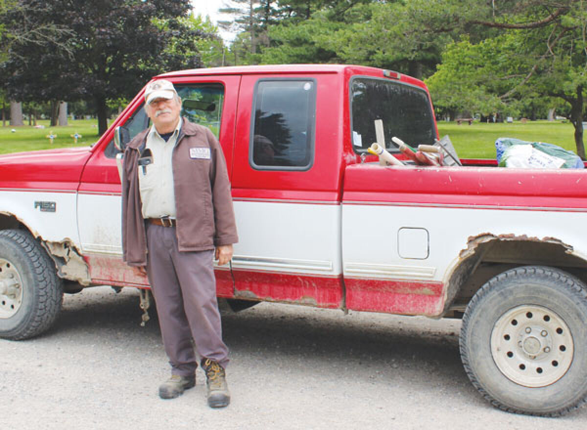  Zygmunt “Ziggy” Koniecki stands in front of his groundskeeper truck at Oakview Cemetery, where he worked for 57 years. Koniecki’s last official day was June 10. 