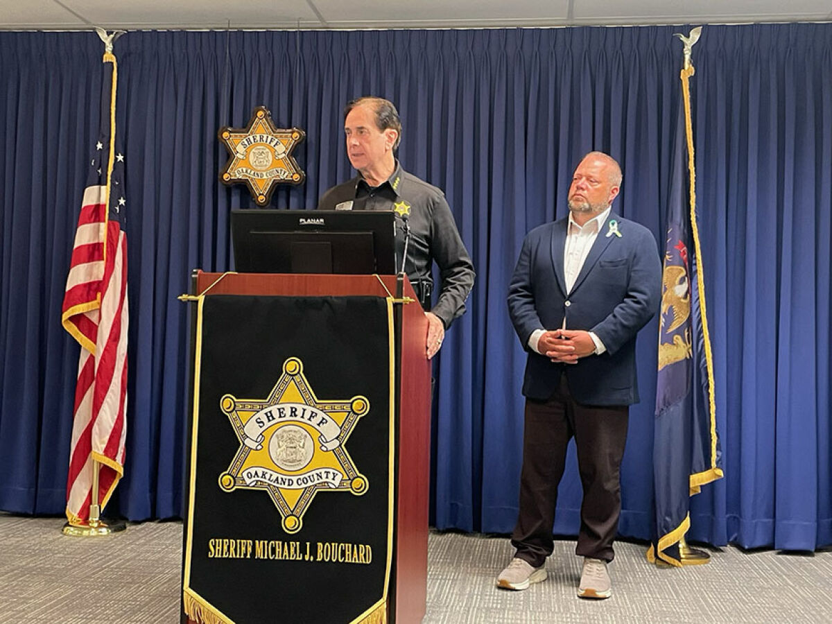  Oakland County Sheriff Mike Bouchard addresses the media during a June 17 press conference regarding the shooting at the Brooklands Plaza Splash Pad. Rochester Hills Mayor Bryan Barnett stands with him. 