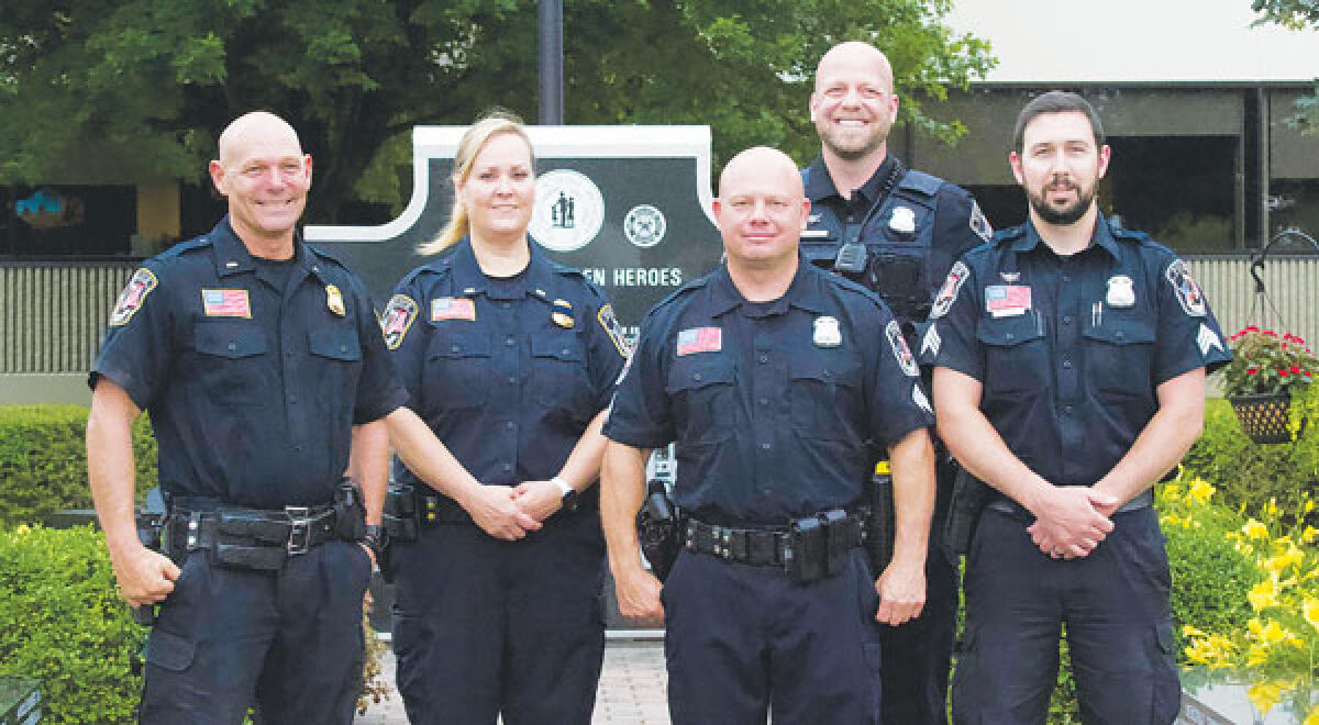  Roseville Police Department members who received a promotion pose for a picture following a ceremony at the June 25 City Council meeting. 