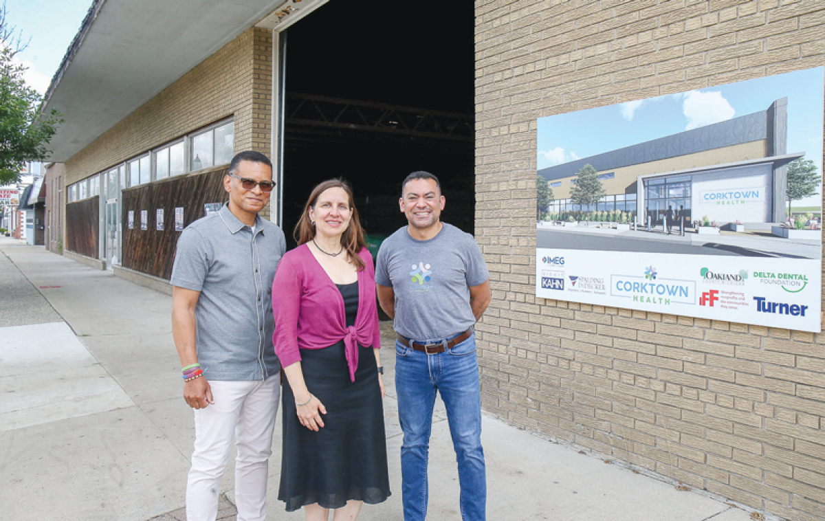  Corktown Health officials stand at the site of the nonprofit’s second clinic, now under construction in Hazel Park. From left to right is Anthony Williams, CEO; Teresa Roscoe, chief operating officer; and Mike Flores, chief financial officer. 