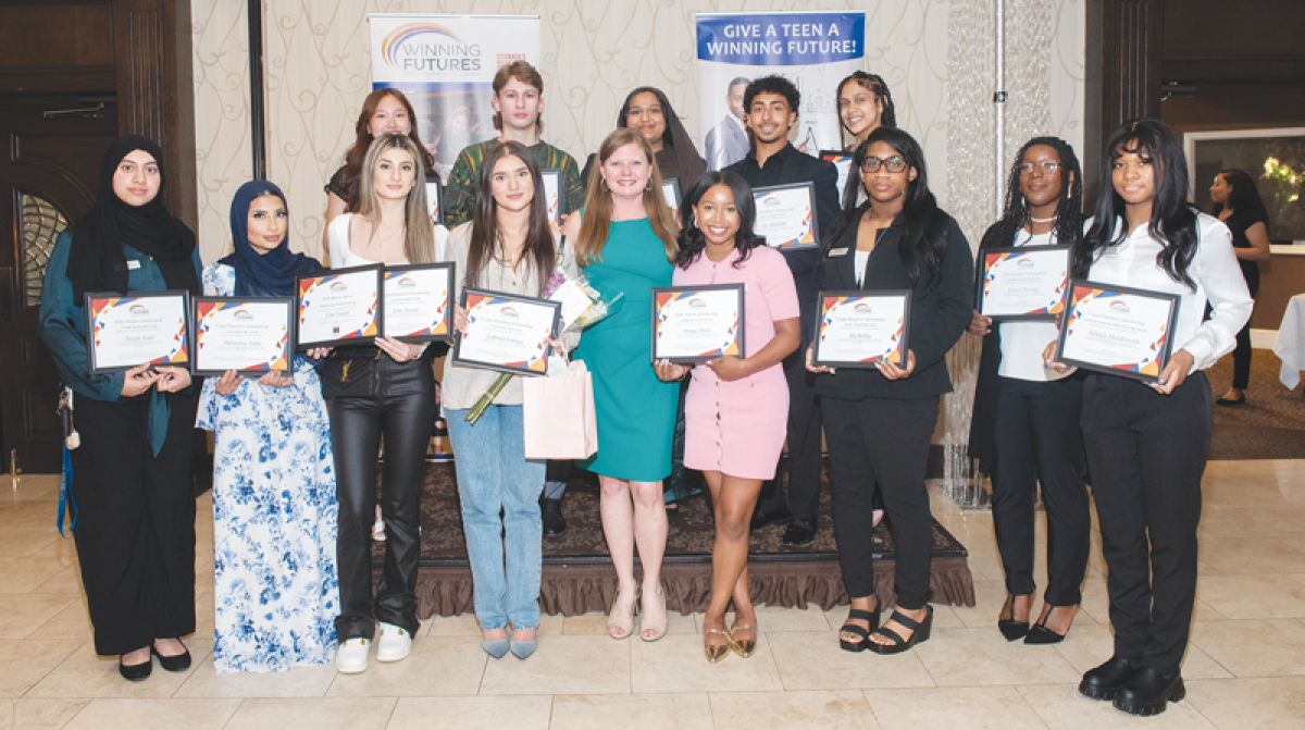  Kris Marshall, president and CEO of Winning Futures, center, with the 2024 Winning Futures Scholarship recipients at the banquet June 10 at Club Venetian in Madison Heights 