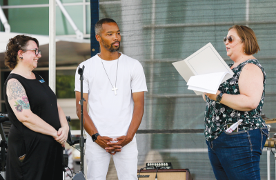  Michael Howard, middle, the founder of Warren’s Juneteenth celebration, and Monica Papasian, left, one of the event sponsors, receive a proclamation from Warren Mayor Lori Stone.  