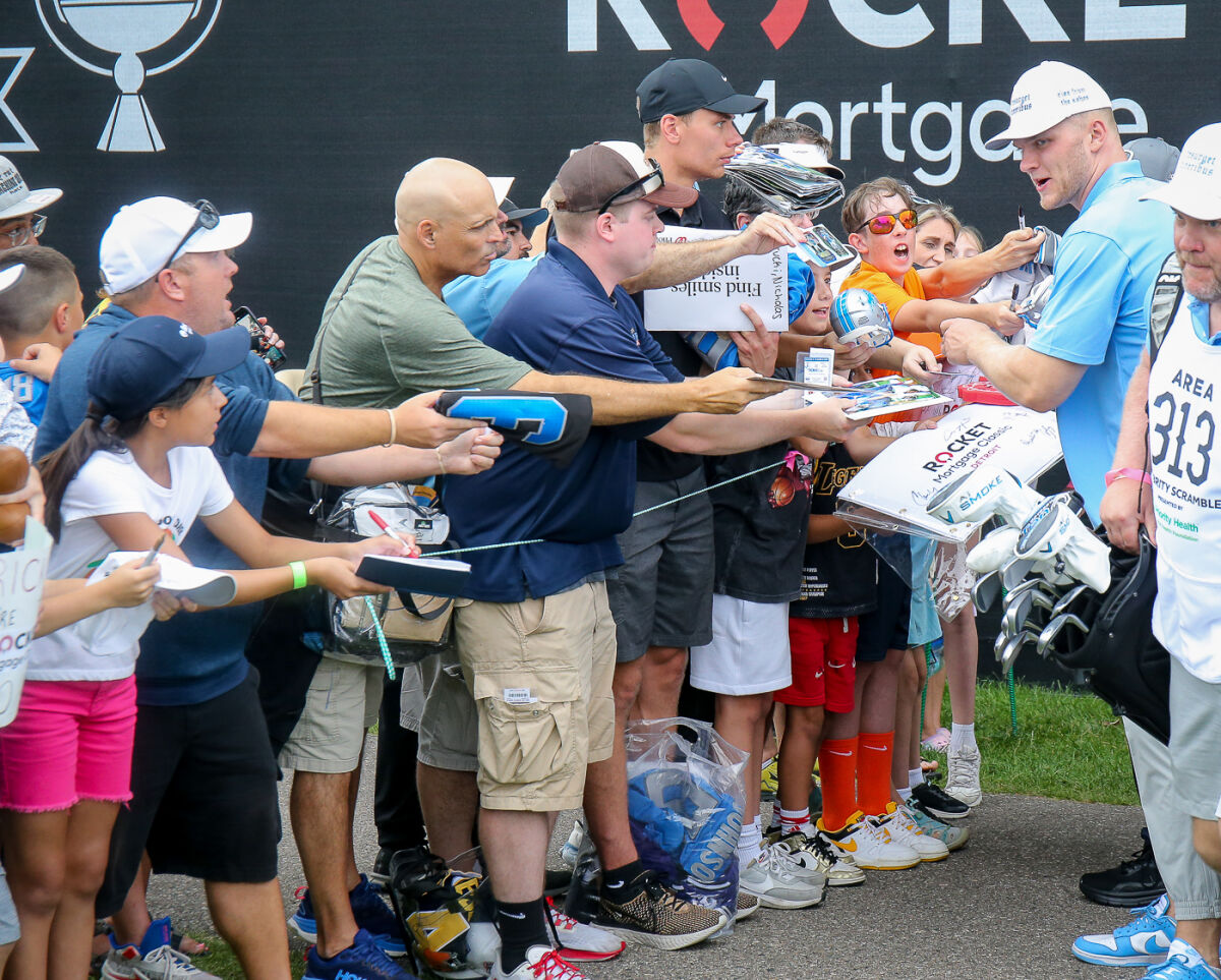  Detroit Lions star Aidan Hutchinson makes time for excited Lions fans by signing autographs on June 25 at Detroit Golf Club. 