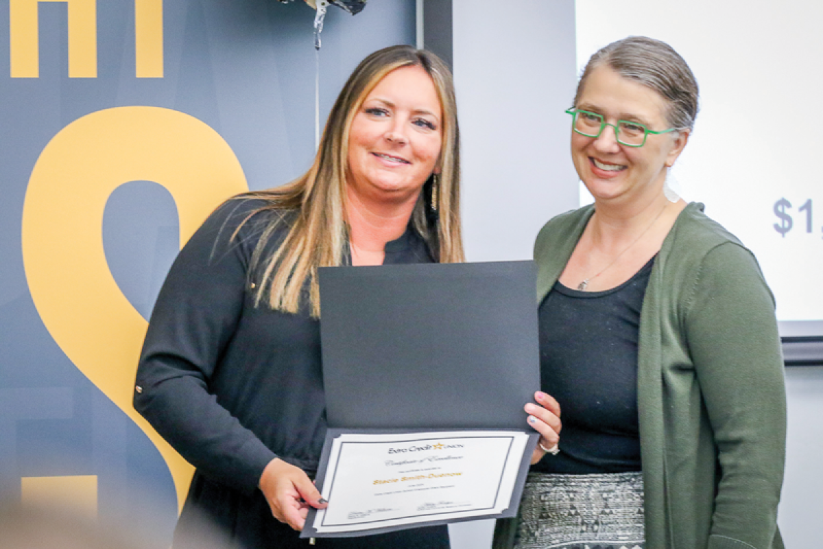  Extra Credit Union School and Community Relations Coordinator  Ashley Fordyce, left, recognizes Stacie Smith-Duenow, who received a $1,500 grant for ceramics in 3D art class at Carleton Middle School. 