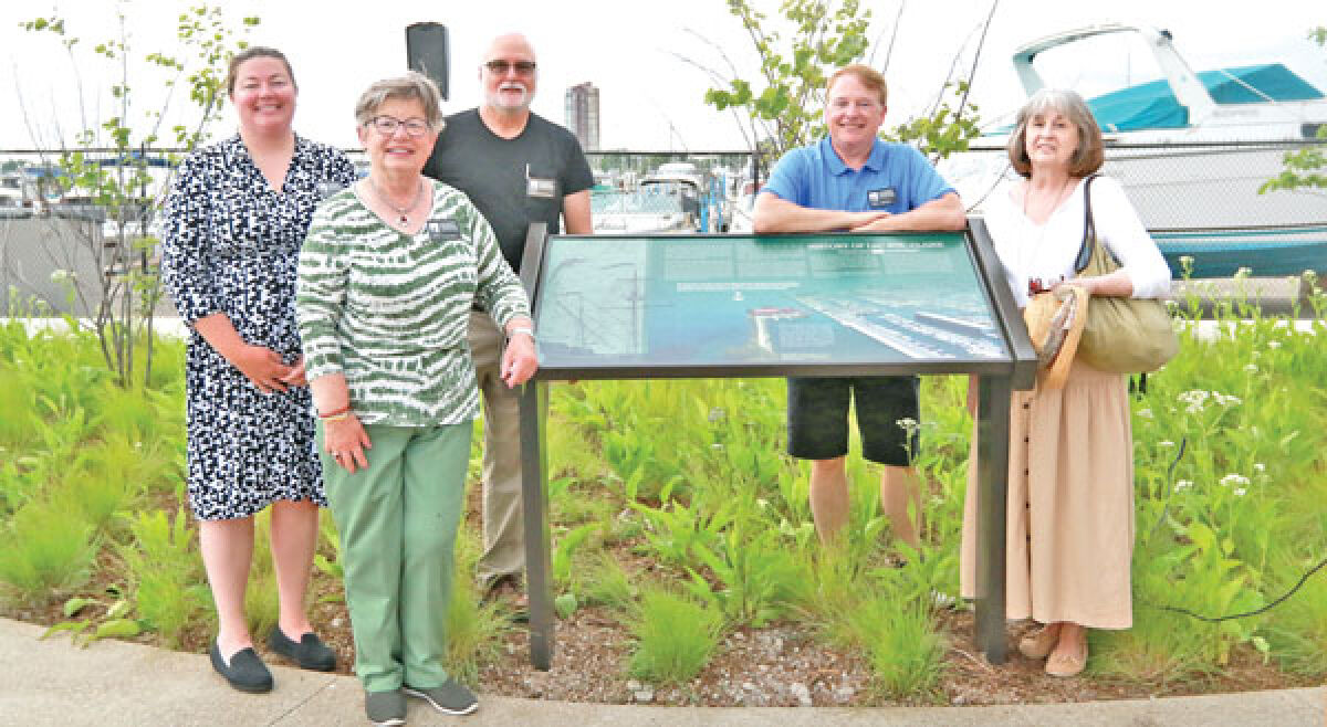  Library Director Stephanie Fair, Historical Commission Treasurer Dawn Zifilippo, Historical Commission Chair Gerald Sielagoski, Councilman John Caron and Historical Commission Secretary Kathleen Campbell stand near the newly dedicated marker at the Blossom Heath Pier. 