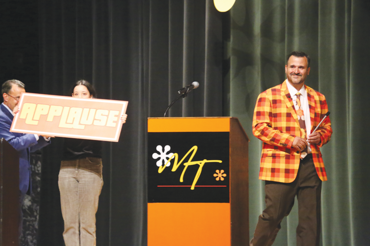  Macomb Township Supervisor Frank Viviano, right, takes the Dakota High School stage for the State of Macomb Township address with a “The Price is Right” theme on June 14. 